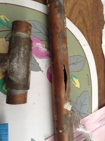 rusted pipe with hole from pipe burst